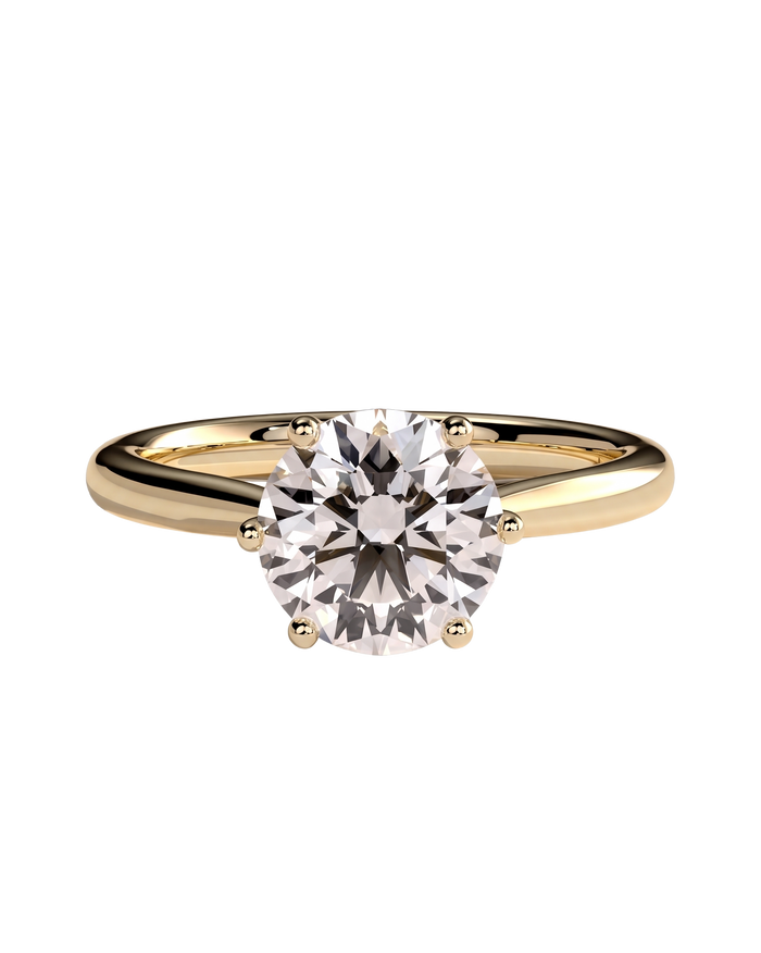 A yellow gold solitaire engagement ring with a single round brilliant diamond held in four prongs.