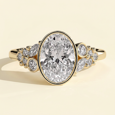 The Gemelle - Oval Cut Lab Grown Diamond Bezel Set Engagement Ring with Clustered Shoulder Accents