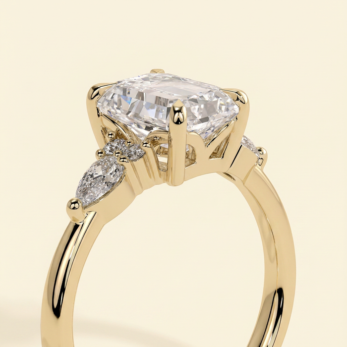 The Belisse - Emerald Cut Lab Grown Diamond Four Claw Solitaire with East West Pear and Round Shoulder Accents Engagement Ring